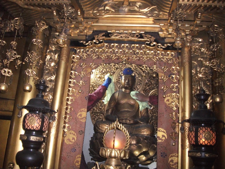 大阪市天王寺区の由緒あるお寺のリフォームで美装工事のご本尊を綺麗にしている様子